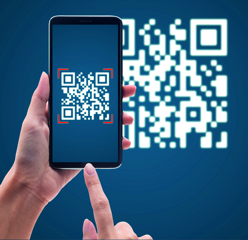 Hand using mobile smart phone scan Qr code on blue background. Cashless technology and digital money concept.