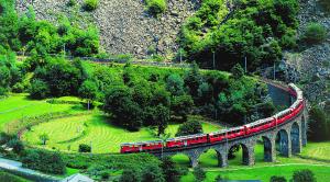 Switzerland. get natural. The unique spiralling viaduct of Brusio in the Poschiavo Valley is part of the spectacular railway trip with the Rhaetian Railway (RhB) crossing the Bernina Pass, Canton Graubuenden. Schweiz. ganz natuerlich. Der weltweit einzigartige Kreisviadukt von Brusio im Puschlav ist Teil der spektakulaeren Bahnfahrt mit der Rhaetischen Bahn (RhB) ueber den Berninapass, Kanton Graubuenden. Suisse. tout naturellement. Le franchissement du viaduc helico dal de Brusio dans le Val Poschiavo, unique au monde, fait partie de la ligne spectaculaire des Chemins de fer rhetiques (RhB) qui traversent le col de la Bernina dans les Grisons. Copyright by: Switzerland Tourism By-Line: swiss-image.ch *** Local Caption *** 65PBernina Express, Brusio, GR, Puschlav