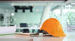 Engineer helmet and drawing equipment. Architectural Office desk construction project.