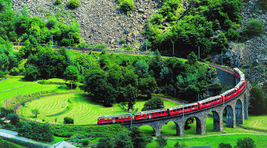 Switzerland. get natural. The unique spiralling viaduct of Brusio in the Poschiavo Valley is part of the spectacular railway trip with the Rhaetian Railway (RhB) crossing the Bernina Pass, Canton Graubuenden. Schweiz. ganz natuerlich. Der weltweit einzigartige Kreisviadukt von Brusio im Puschlav ist Teil der spektakulaeren Bahnfahrt mit der Rhaetischen Bahn (RhB) ueber den Berninapass, Kanton Graubuenden. Suisse. tout naturellement. Le franchissement du viaduc helico dal de Brusio dans le Val Poschiavo, unique au monde, fait partie de la ligne spectaculaire des Chemins de fer rhetiques (RhB) qui traversent le col de la Bernina dans les Grisons. Copyright by: Switzerland Tourism  By-Line: swiss-image.ch   *** Local Caption *** 65PBernina Express, Brusio, GR, Puschlav